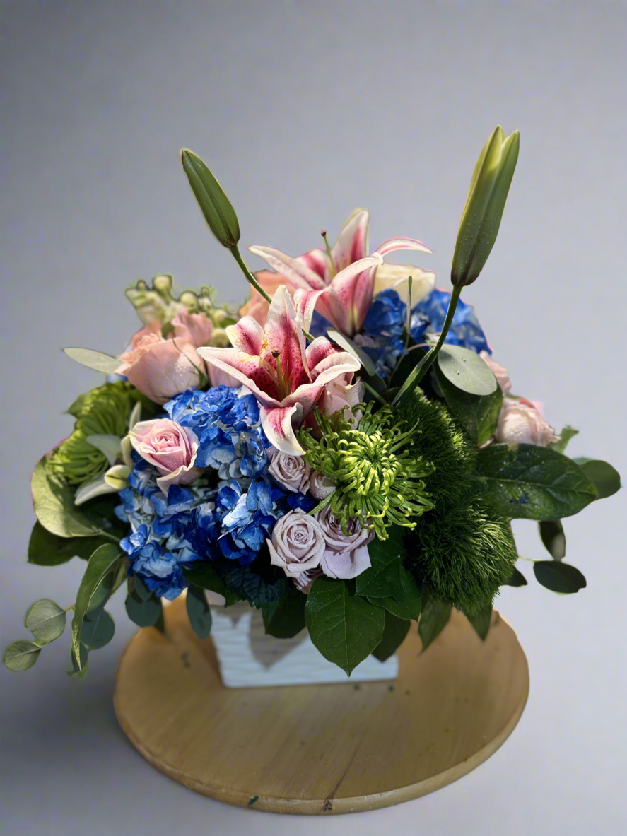 Flower arrangement with blue, green and pink