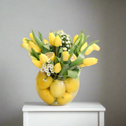 Fresh lemon with yellow tulips arrangement 