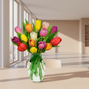 Bouquet of colorful tulips in a clear vase on a table in a modern room.